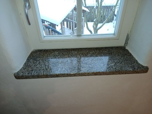 stone carving artisan working on granite monument